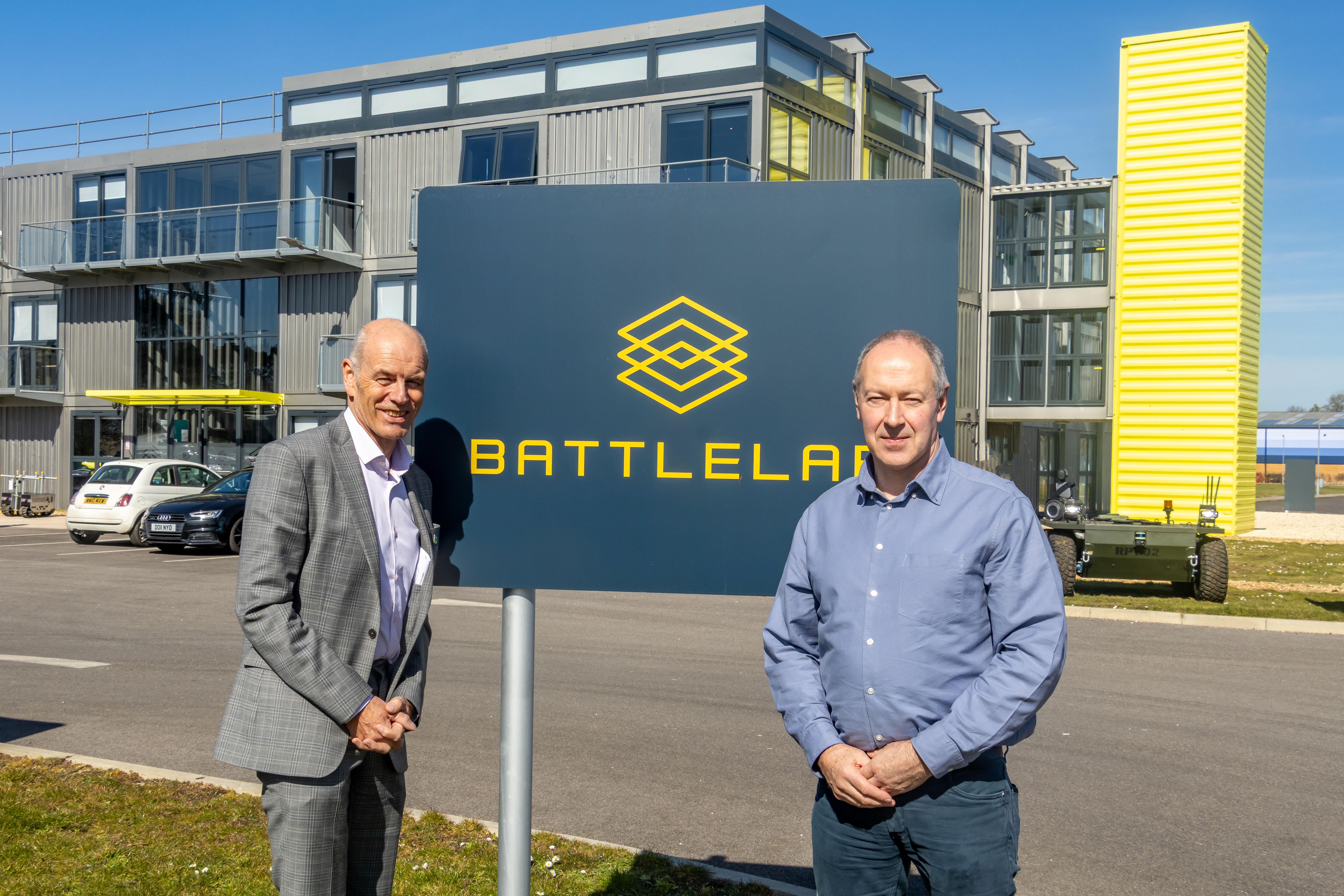 Cllr Richard Biggs and Cllr Nick Ireland pictured in front of the BattleLab sign at the Dorset Innovation Park in Winfrith