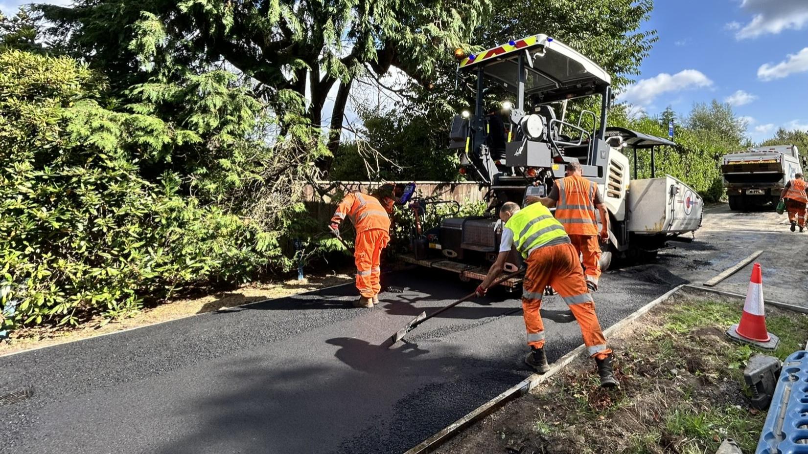 Highways workers resurfacing pathway