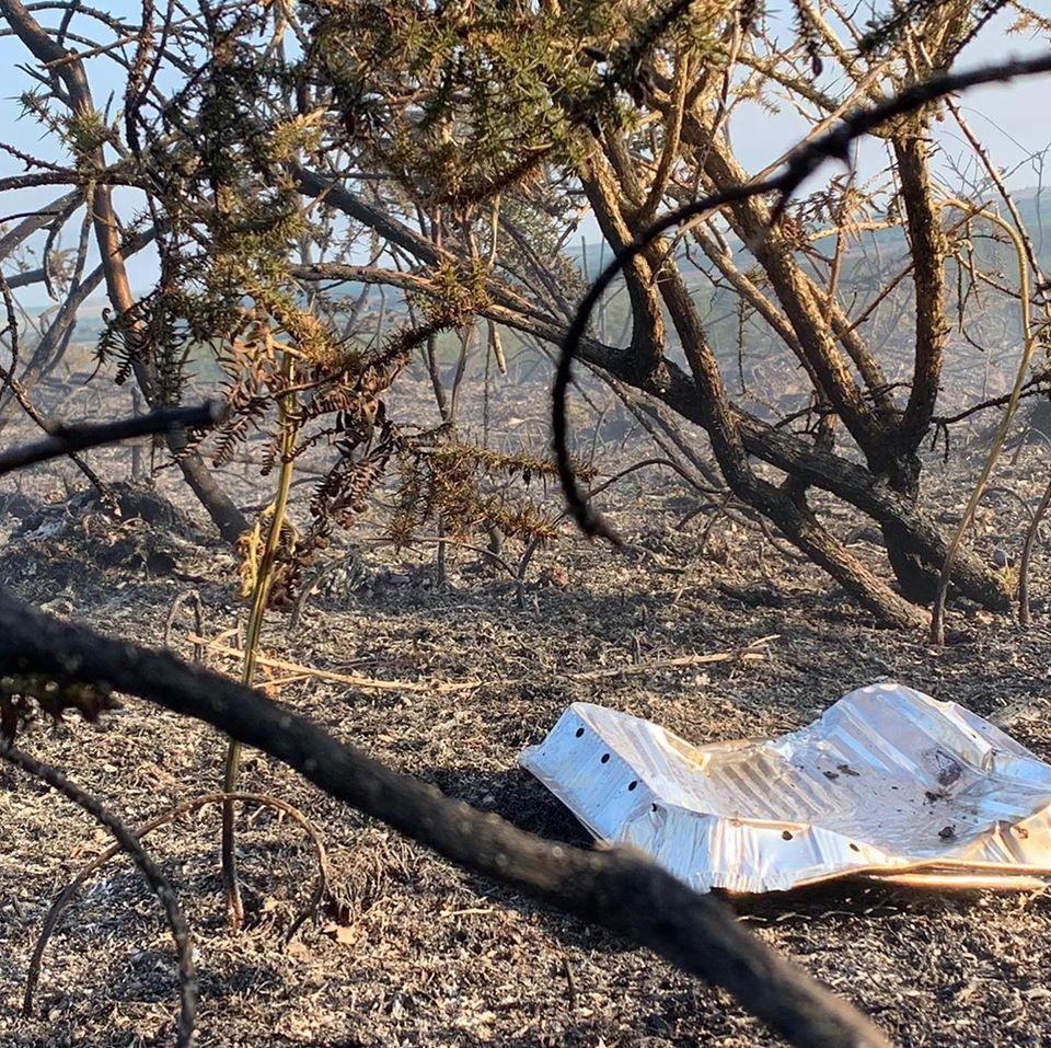 A charred heathland and discarded disposable BBQ