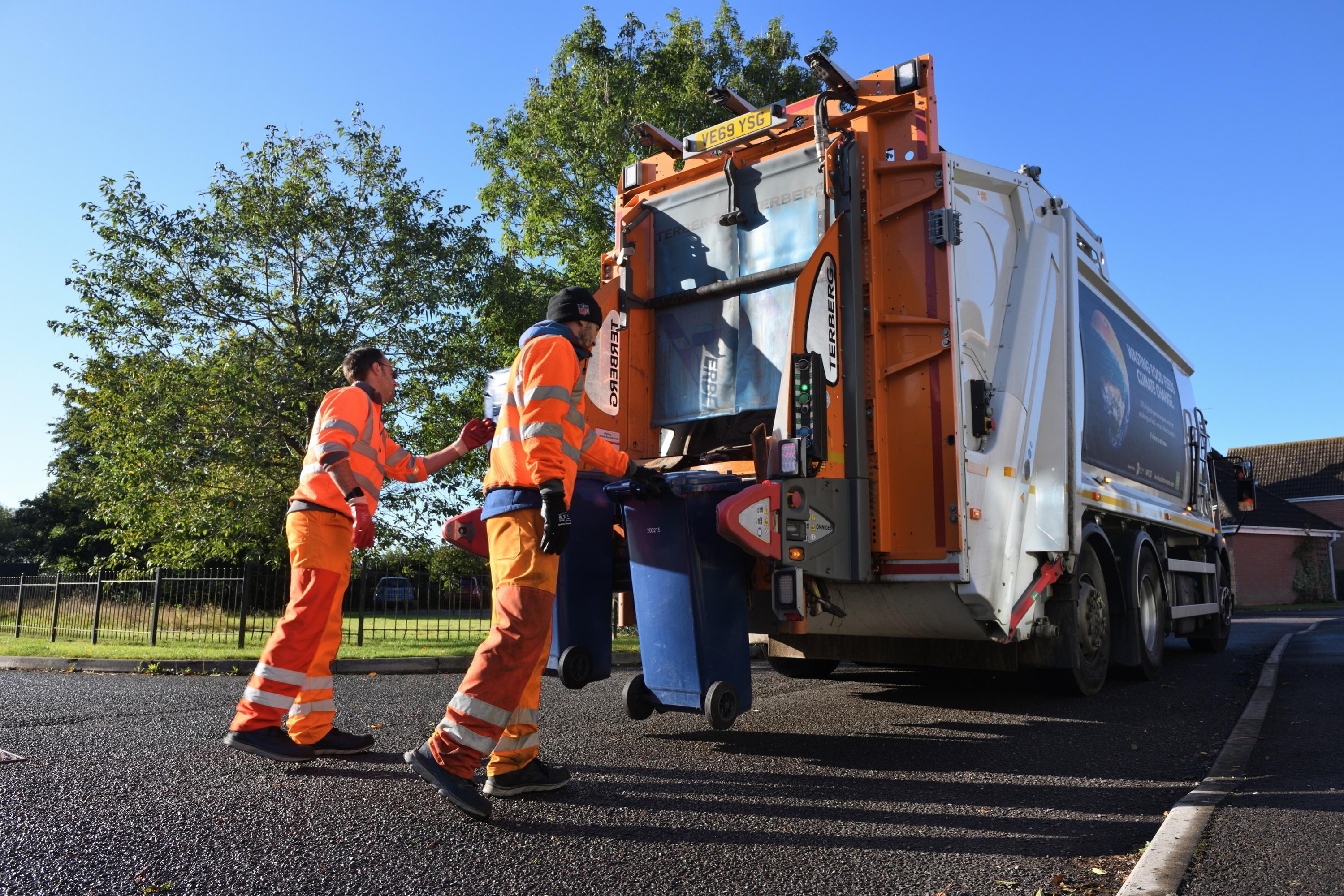 Bin collection crew loading vehicle
