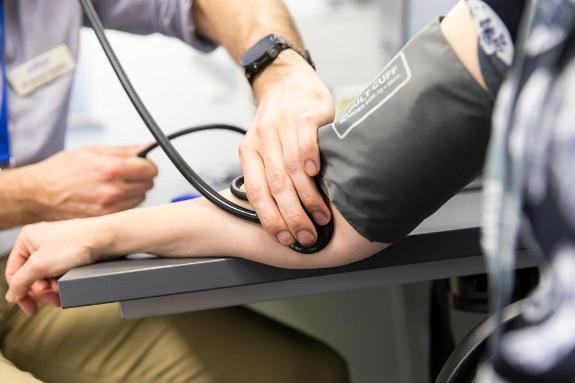 Close up on doctor using stethoscope